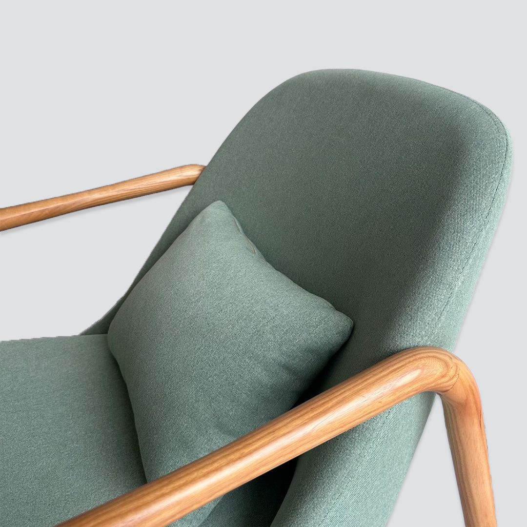 Wooden armchair in light green fabric